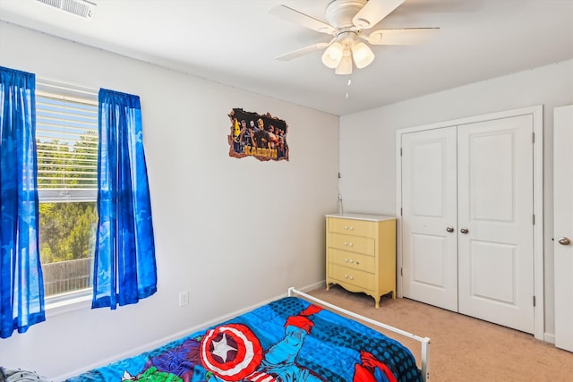 carpeted bedroom featuring baseboards, a ceiling fan, visible vents, and a closet