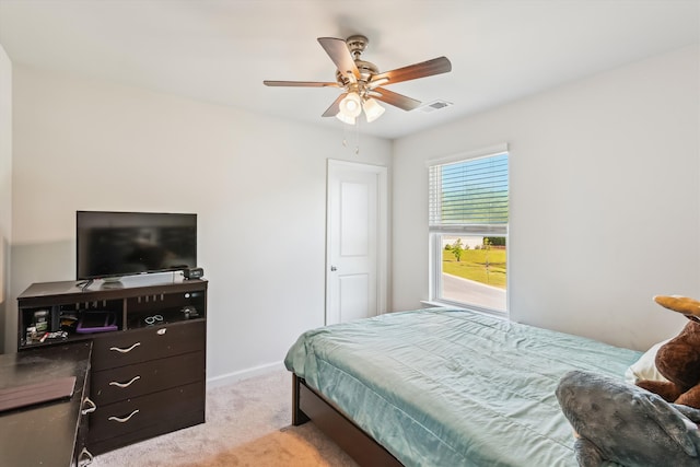 bedroom featuring light colored carpet, ceiling fan, baseboards, and visible vents
