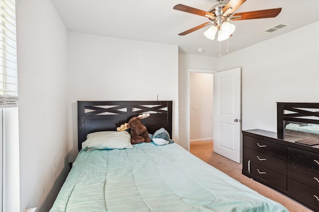 bedroom featuring ceiling fan, light carpet, and visible vents