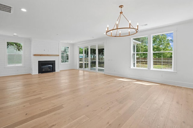 2006 Riverbend Dr, Charleston, SC 29412 - unfurnished living room featuring a chandelier, light wood-style flooring, baseboards, recessed lighting, and a glass covered fireplace
