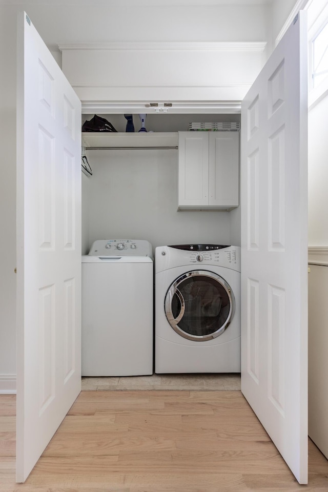 1532 Sea Palms Cres, Mount Pleasant, SC 29464 - laundry area with cabinet space, washing machine and clothes dryer, and light wood-type flooring