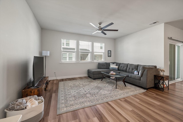 living room featuring ceiling fan and hardwood / wood-style floors