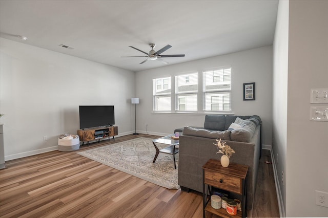 living room with hardwood / wood-style flooring and ceiling fan