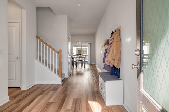 entryway featuring light hardwood / wood-style floors and a notable chandelier