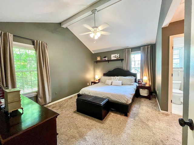 carpeted bedroom featuring baseboards, ensuite bath, and ceiling fan