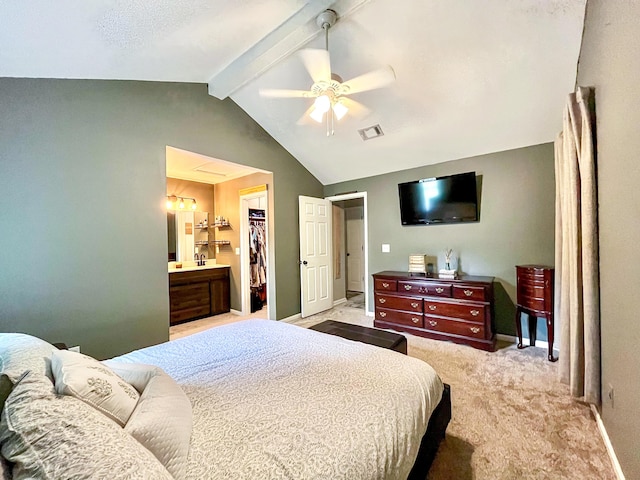 bedroom with light colored carpet, a walk in closet, a closet, ceiling fan, and baseboards