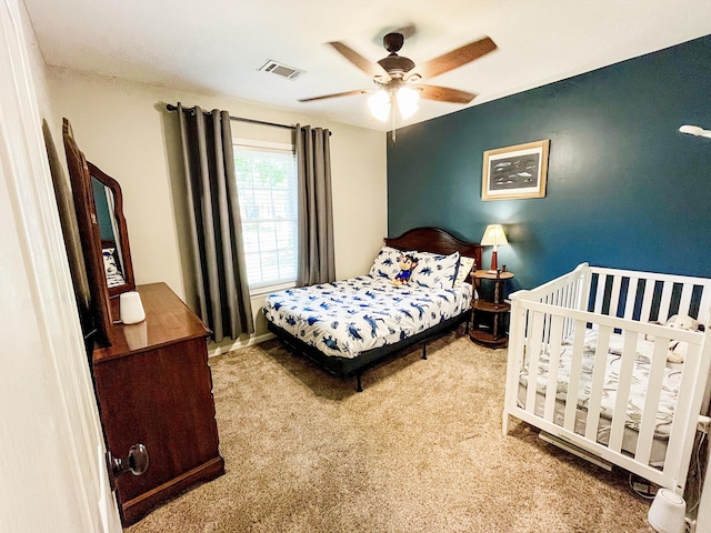 carpeted bedroom with a ceiling fan and baseboards