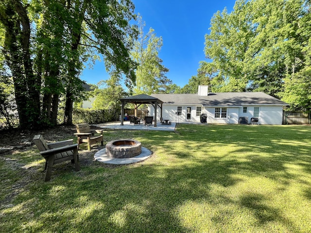 back of house featuring an outdoor fire pit, a gazebo, a patio, and a chimney