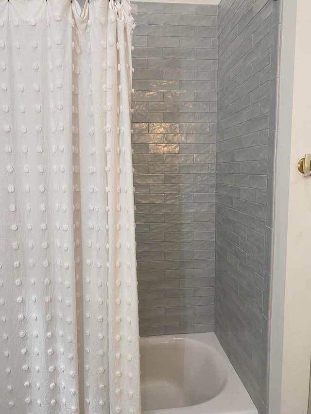 bathroom with shower / bath combination with curtain