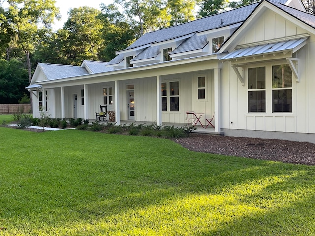 modern inspired farmhouse featuring a porch and a front lawn