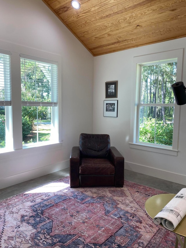 living area featuring wooden ceiling, a wealth of natural light, and vaulted ceiling