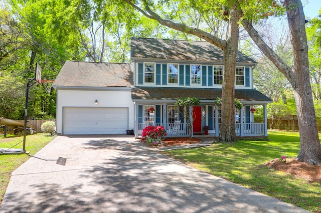 colonial inspired home featuring covered porch, a front yard, fence, an attached garage, and driveway