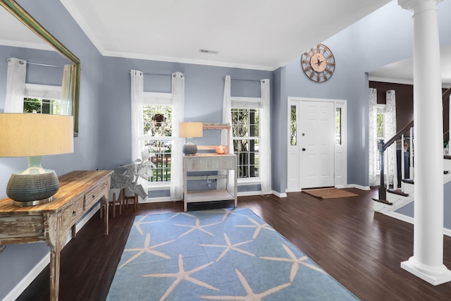 entrance foyer featuring baseboards, ornamental molding, stairway, visible vents, and wood finished floors