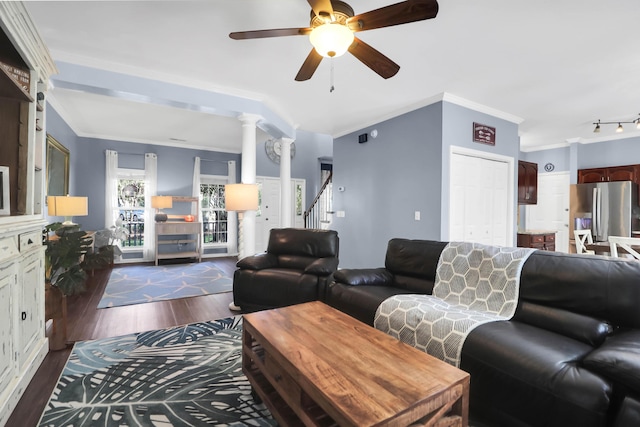living area with crown molding, ceiling fan, lofted ceiling, stairs, and dark wood-style floors