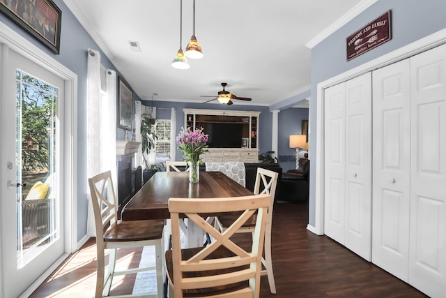 dining space with plenty of natural light, ornamental molding, a ceiling fan, and wood finished floors