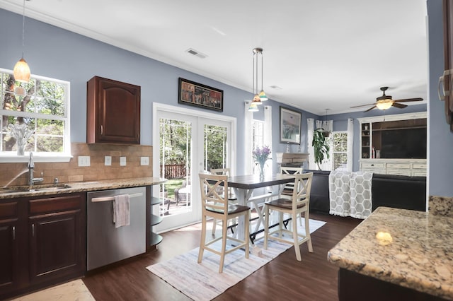 kitchen with visible vents, a healthy amount of sunlight, dishwasher, a sink, and backsplash