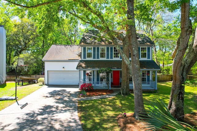 view of front of home with a porch, driveway, a front yard, and fence