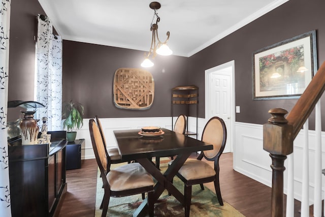 dining room with crown molding, dark wood-style flooring, wainscoting, and stairway