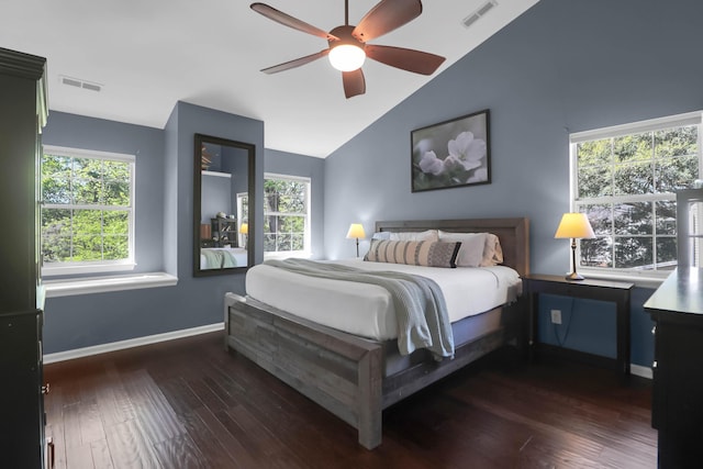 bedroom featuring visible vents, baseboards, vaulted ceiling, and wood finished floors