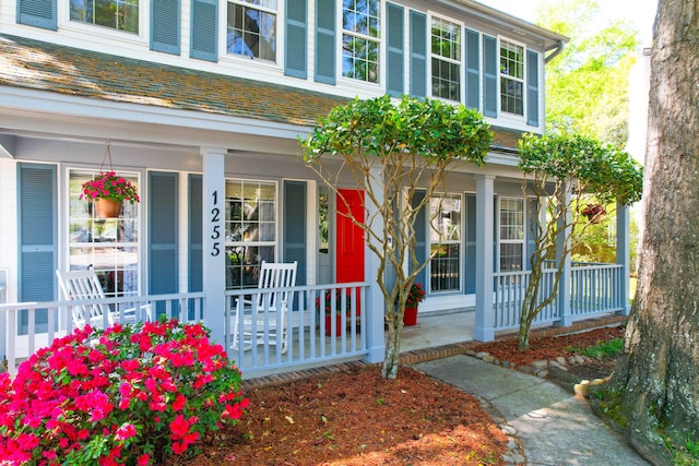 view of exterior entry with a porch