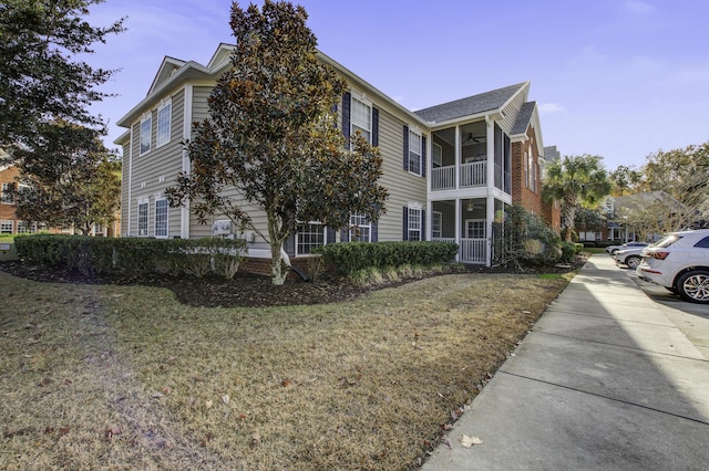 view of property exterior featuring a yard and ceiling fan