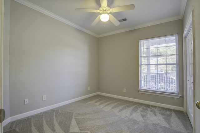 carpeted empty room featuring crown molding and ceiling fan