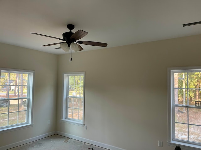 spare room with a healthy amount of sunlight and ceiling fan