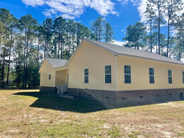 view of side of property with a yard