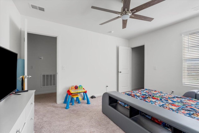 bedroom with visible vents, light carpet, baseboards, and a ceiling fan