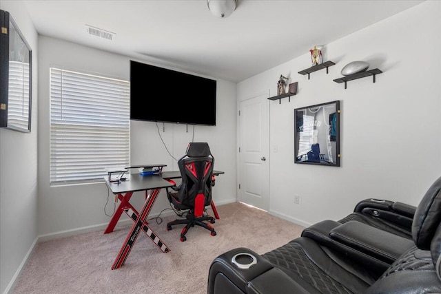 carpeted home office featuring visible vents and baseboards