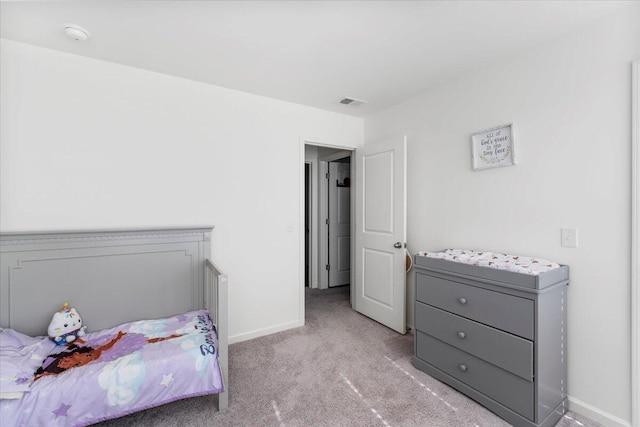 bedroom featuring visible vents, light colored carpet, and baseboards