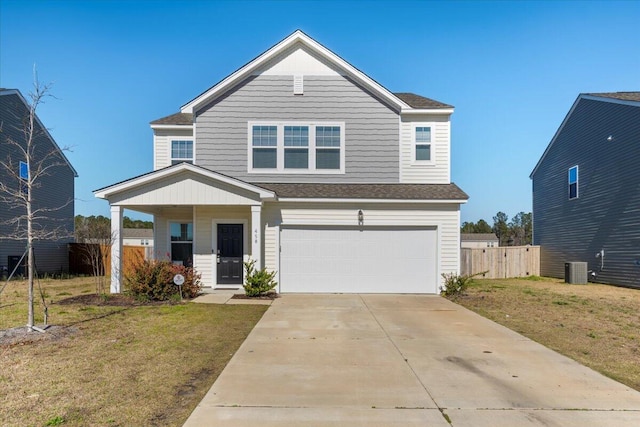 view of front of home with a garage, concrete driveway, a front yard, and fence