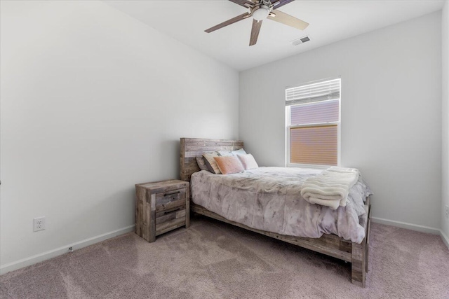 carpeted bedroom featuring visible vents, ceiling fan, and baseboards