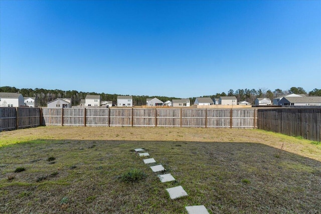 view of yard with a residential view and a fenced backyard