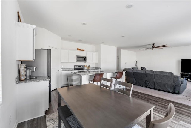 dining room featuring ceiling fan and wood finished floors