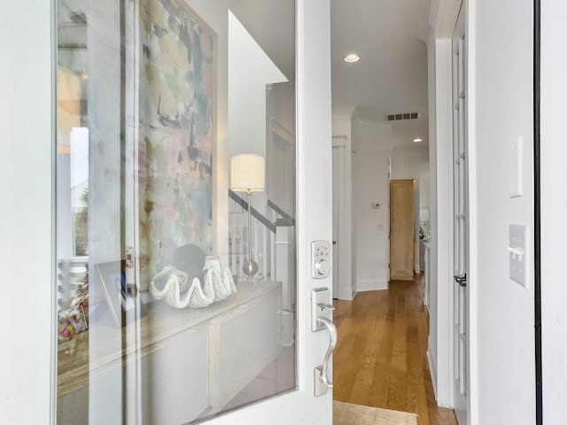 corridor featuring visible vents, recessed lighting, and wood finished floors