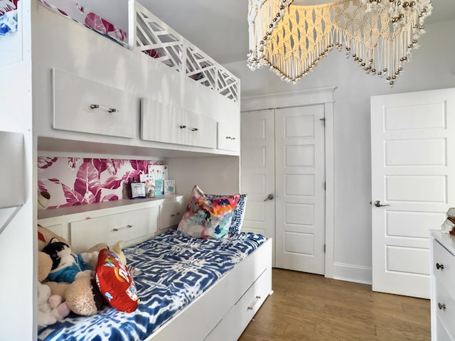 bedroom featuring baseboards and wood finished floors
