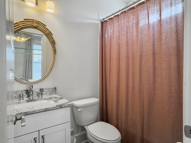 bathroom with toilet, a shower with shower curtain, and vanity