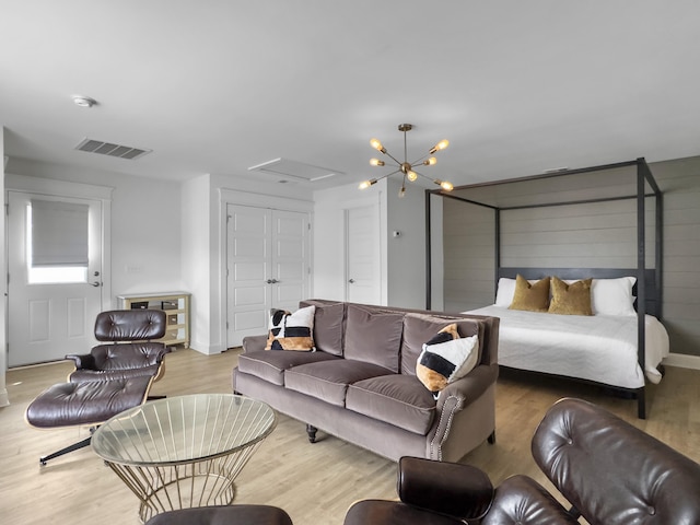 living area with visible vents and wood finished floors