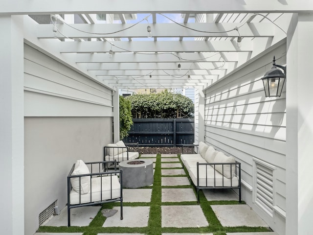 view of patio with an outdoor fire pit, fence, and visible vents