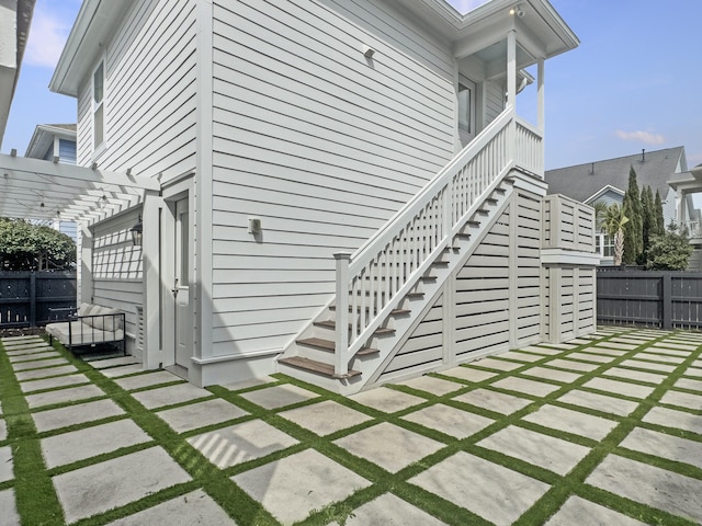 exterior space featuring a pergola, fence, and a patio
