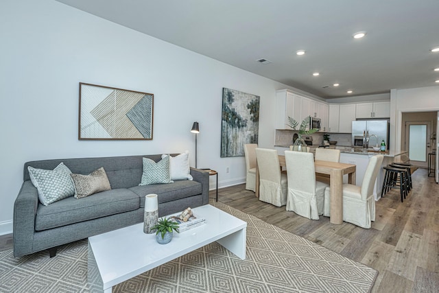 living room with light hardwood / wood-style flooring