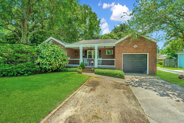 view of front of house featuring a front yard, a porch, and a garage