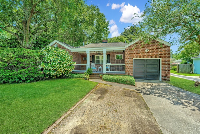 view of front facade featuring a garage, covered porch, and a front yard