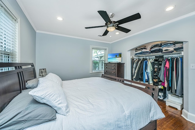 bedroom with dark hardwood / wood-style flooring, ornamental molding, a closet, and ceiling fan