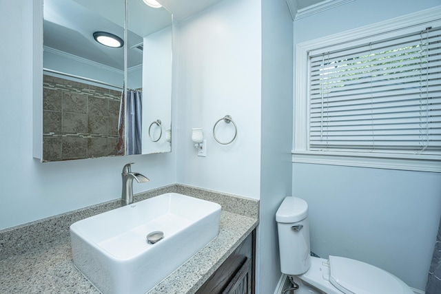 bathroom featuring a shower with curtain, vanity, crown molding, and toilet