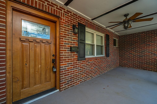 entrance to property featuring ceiling fan