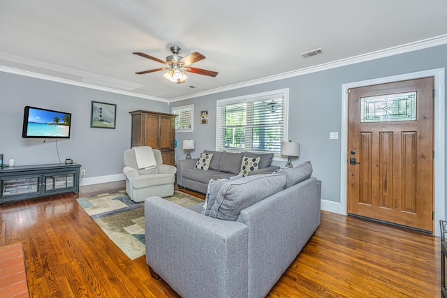 living room featuring dark hardwood / wood-style flooring, crown molding, and ceiling fan