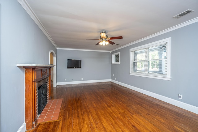 unfurnished living room with crown molding, dark hardwood / wood-style floors, and a tiled fireplace