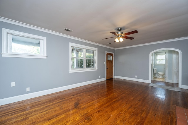 spare room with ornamental molding, dark wood-type flooring, and ceiling fan